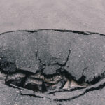 Deep,Sinkhole,On,Asphalt,With,Cracks